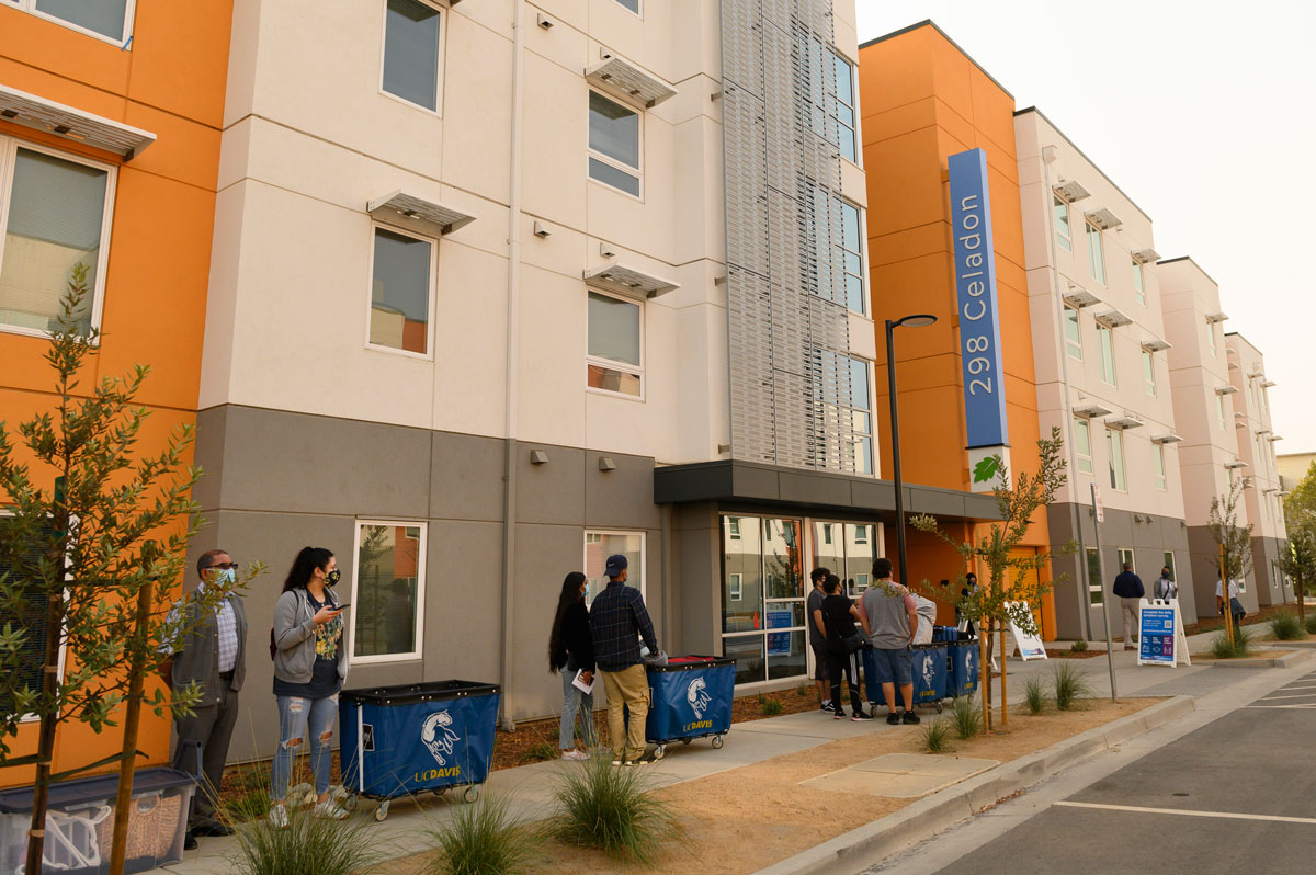 Students wait in line outside The Green apartment complex.