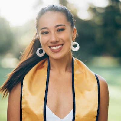 Brooke wears a graduation sash. 