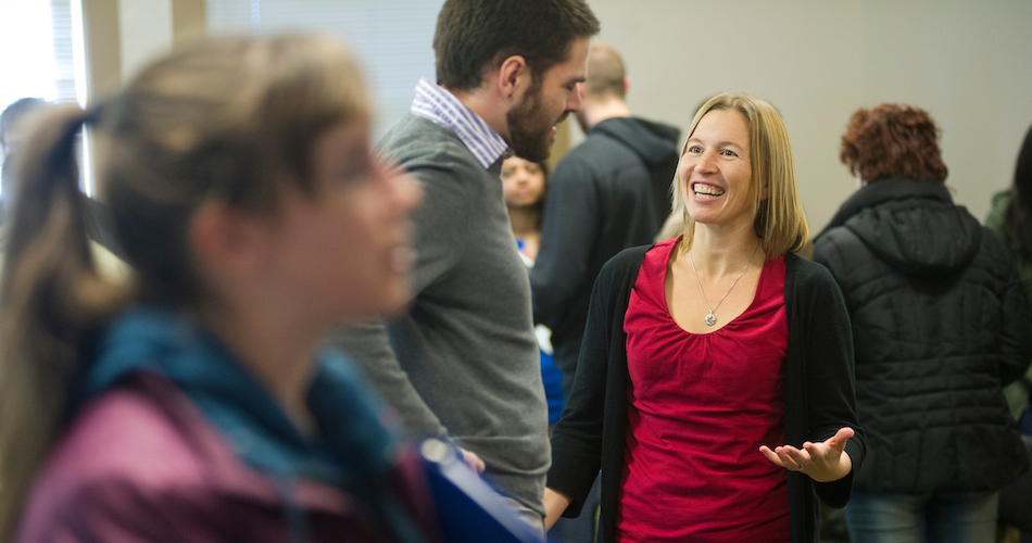 Alumna Colleen Hiner (red shirt) and Master's candidate Ryan Mayfield (gray sweater) practice their introductions during a GradPathways workshop in South Hall on June 11, 2013. The workshop is preparing students for an upcoming on campus job fair.