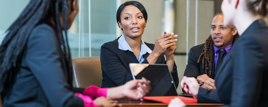 Woman looking at colleague across conference table