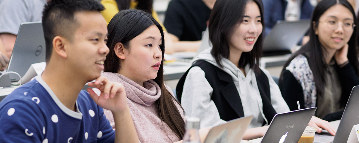 YiYi Han, second from left, with other business students seated in a classroom