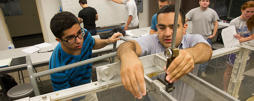 UC Davis civil and environmental engineering graduate student Kaveh Zamani, right, showing a student how to use an instrument