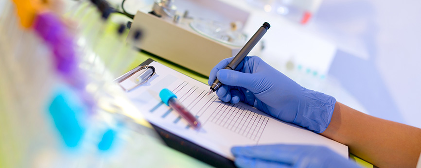 Female hands in gloves working on a chart in a medical setting