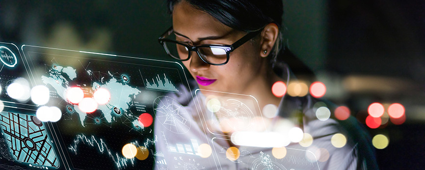 A woman looking at a transparent screen with many  images