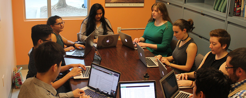 Students sitting around a large table conversing