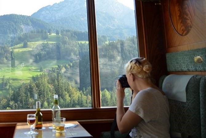 Jackie DesForges shoots a photo out the window from a train