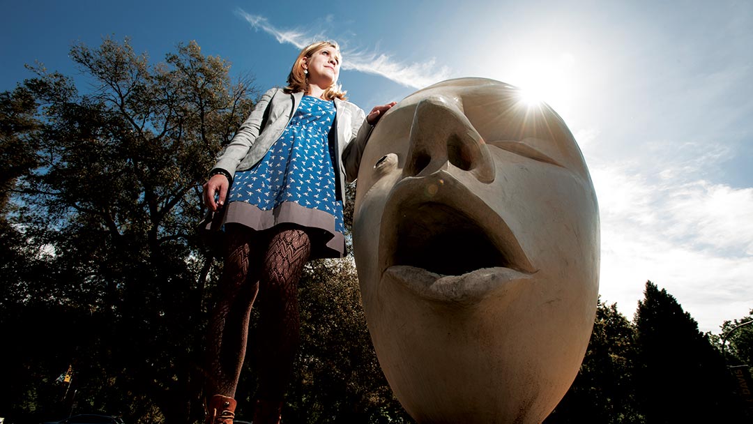 A woman stands by one of the campus' Eggheads.