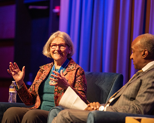 Sister Simone Campbell on stage with Chancellor Gary S. May