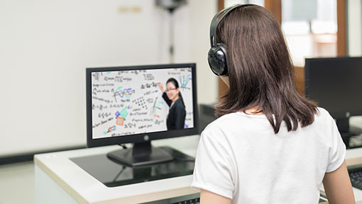 Student watches lecture on computer.