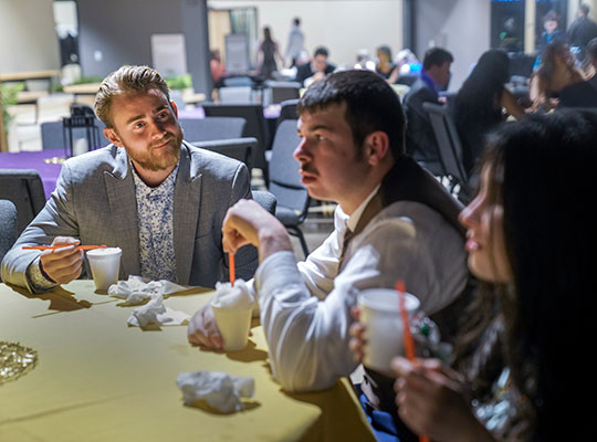 Quarterback Brock Johnson, left, talked with guests Natalie Eddy and her boyfriend, Sam Ghilardi.