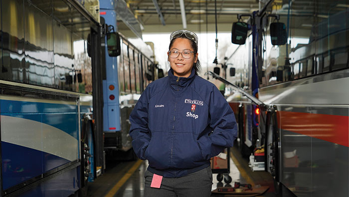 Alumna Kimmy Nguyen in a bus yard