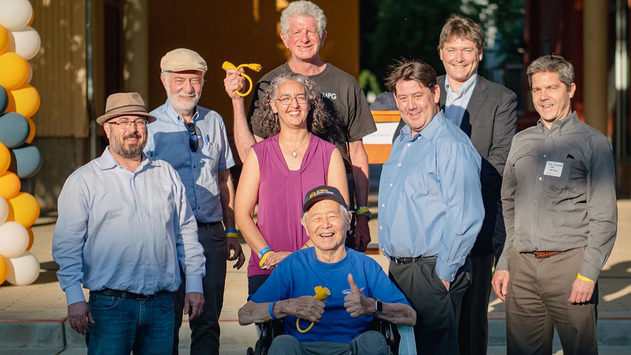 A group of seven people surround Professor Andy Frank