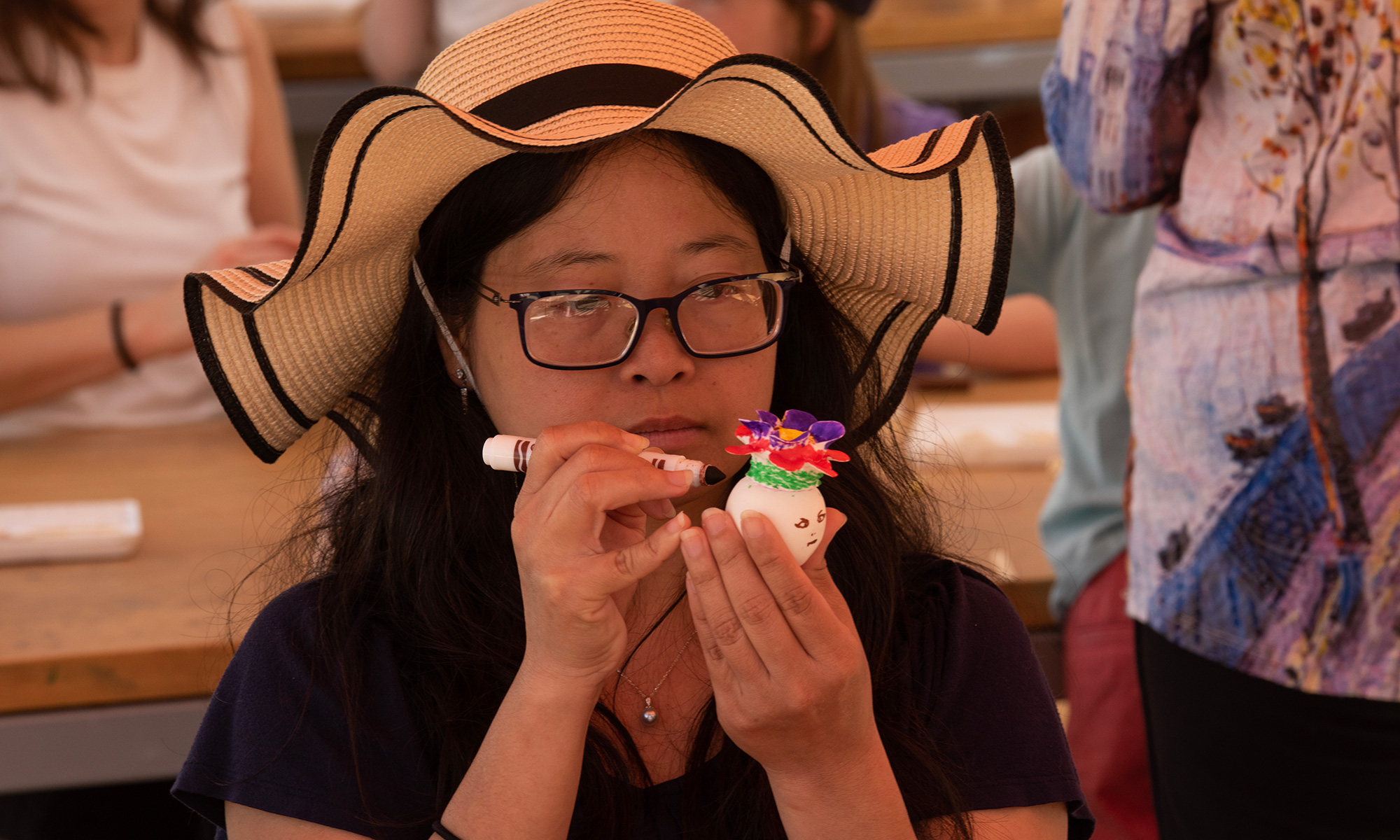 Woman paints a small egg