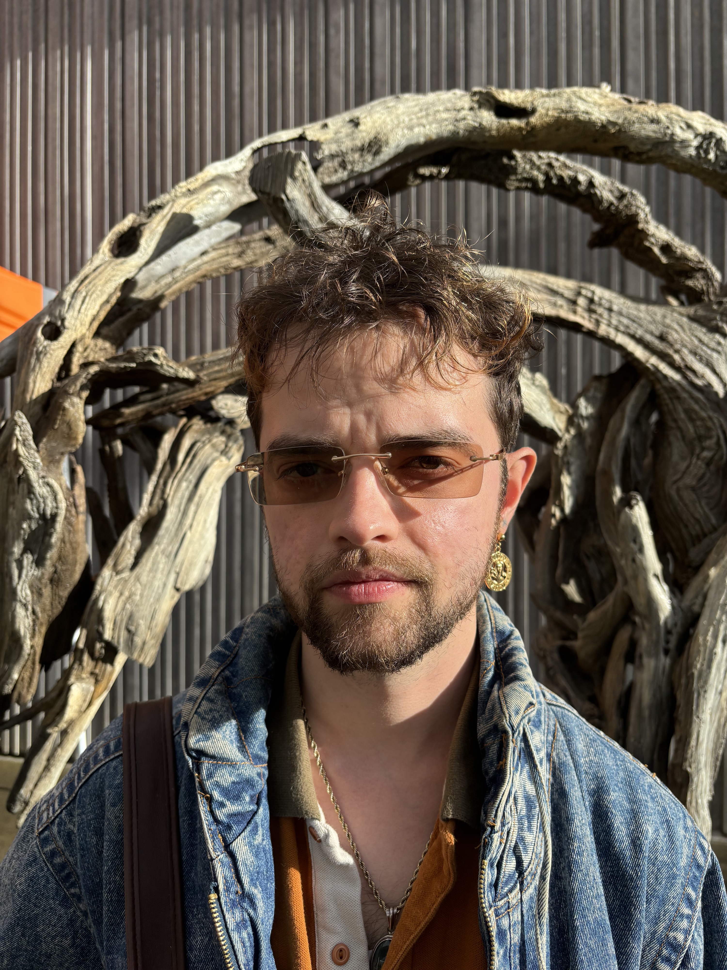 Trevor Bashaw headshot wearing sunglasses and a denim jacket