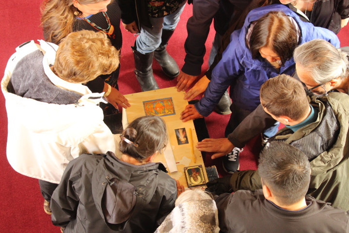 Group in church and small casket in middle