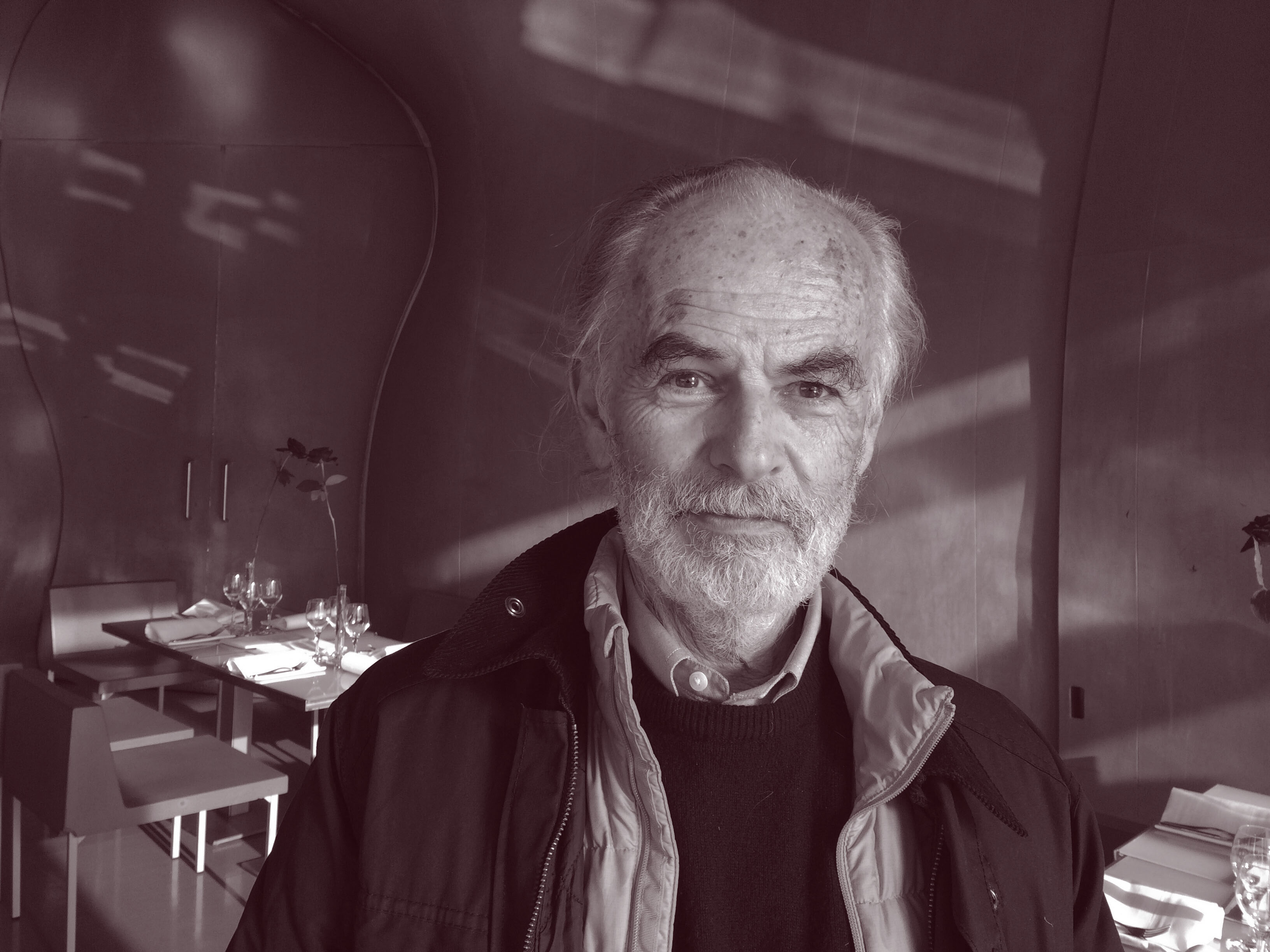 man in vest and jacket in black-and-white photo