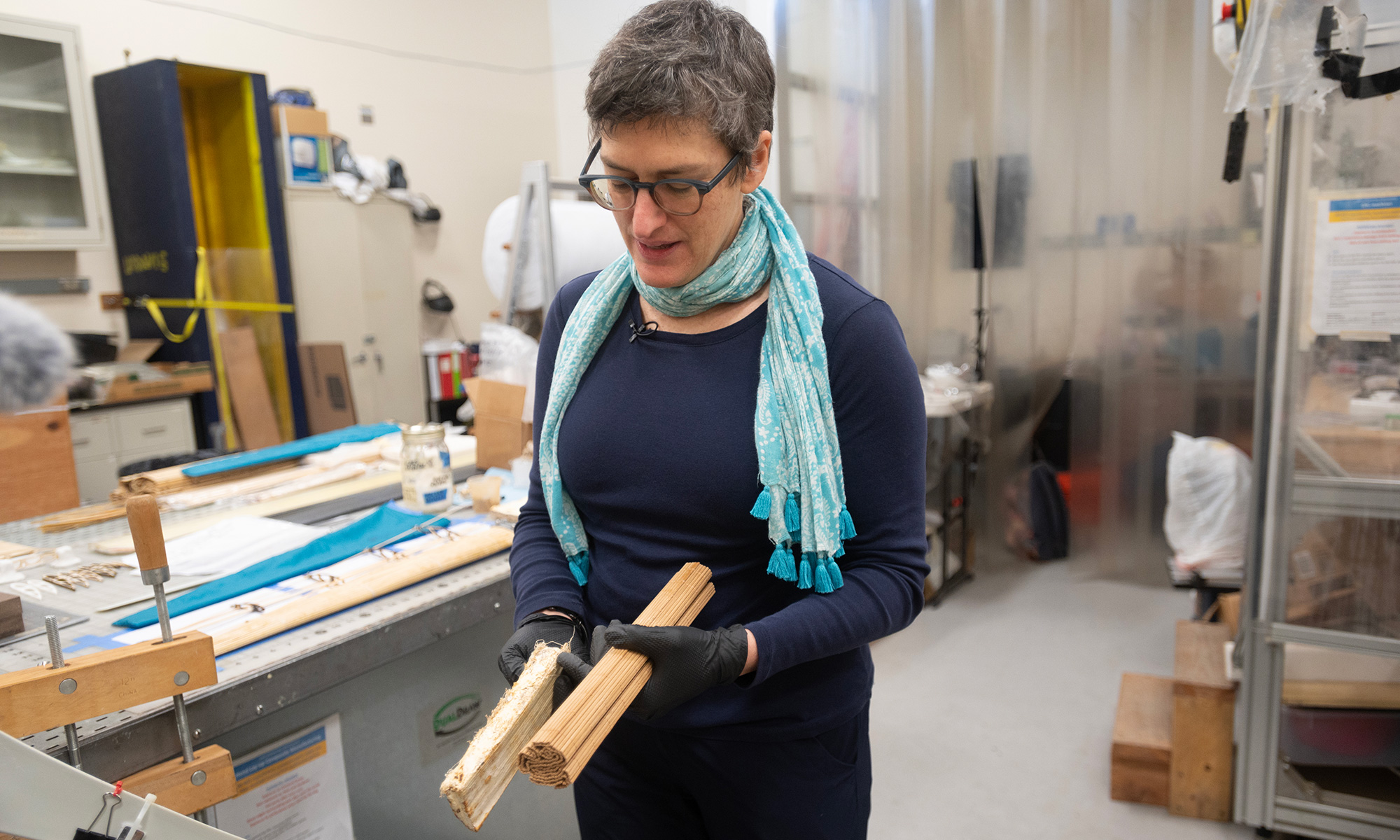 Woman holds rectangular materials in a lab