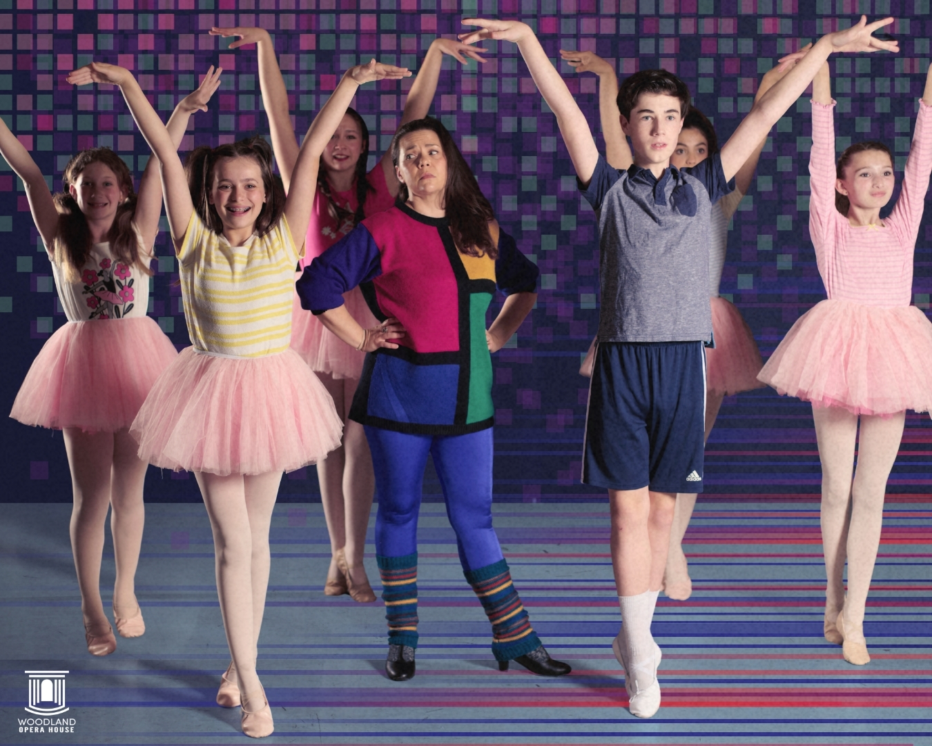 Five young dancers on colorful stage, three in pink tutus, one in multicolor, one in gray