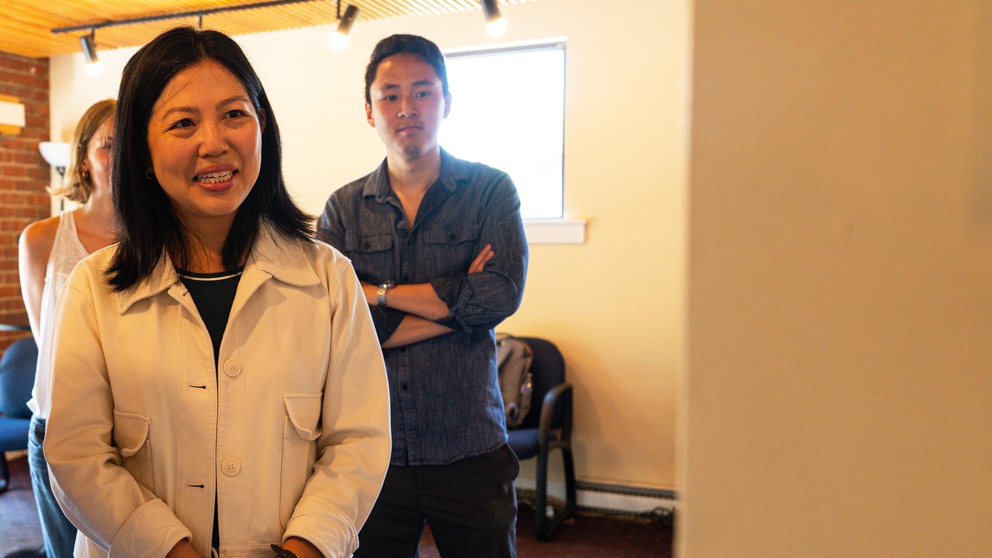 Woman stands and looks at a display on the wall of a lobby