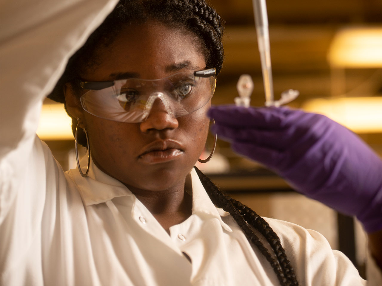 Tiffany Phillips, a focused biochemistry major, performing an ethanol precipitation supernatant in a lab, as part of the UC-HBCU program.