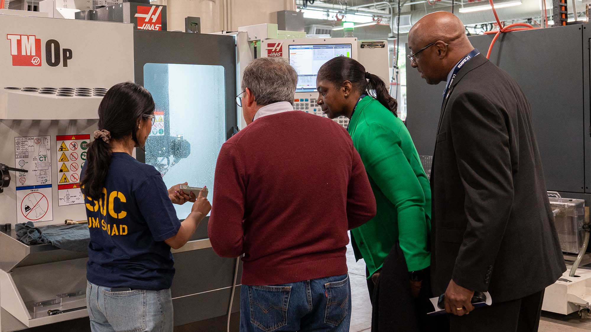 Student demonstrates CNC machine.