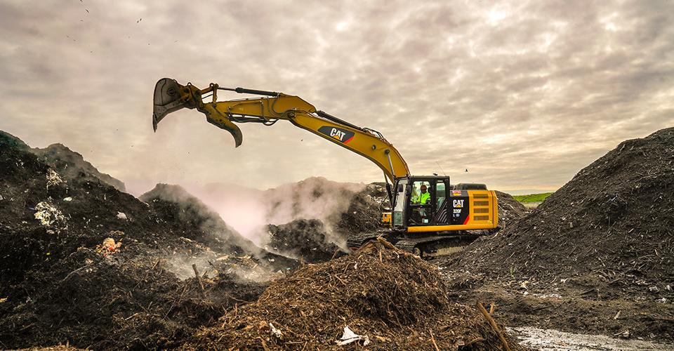 excavator moving compost