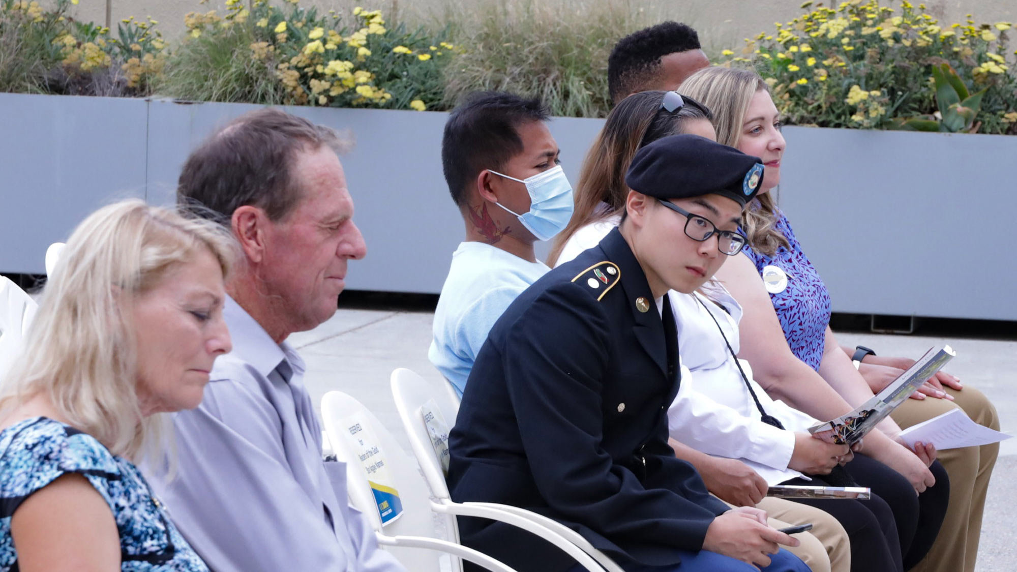 Man and woman in front row of ceremony