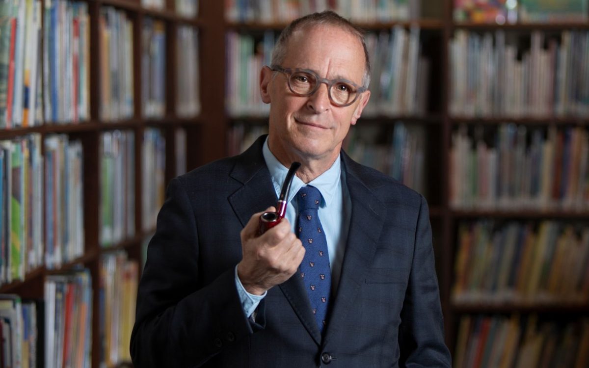 Photo of speaker in front of books