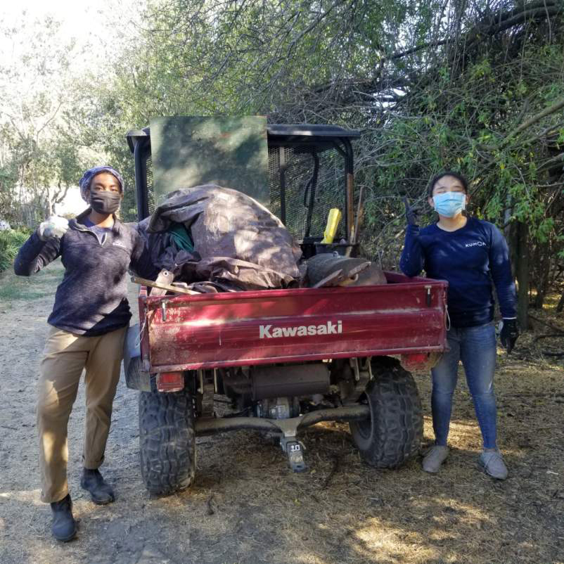 Two students pose next to a tractor at UC Davis. 