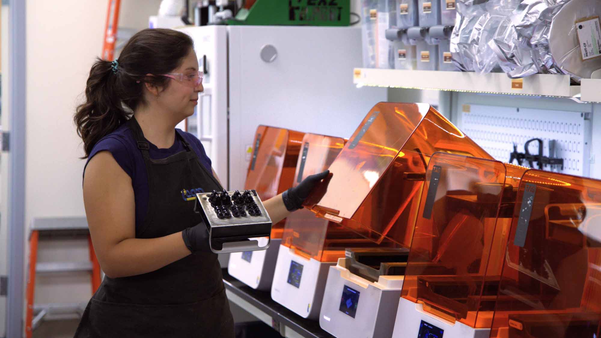 Valerie Quiroz, a development engineer for the UC Davis Translating Engineering Devices to Medicine (TEAM) Lab, using a 3D printer to develop medical devices.