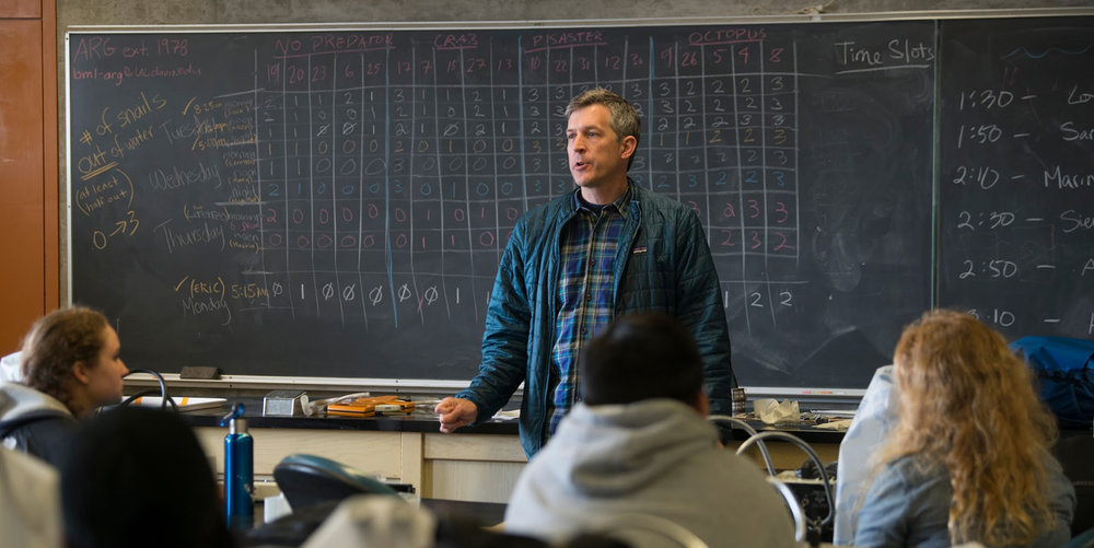Professor Sanford stands in front of a classroom at UC Davis. 