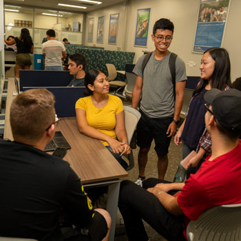 a group of student talking in classroom