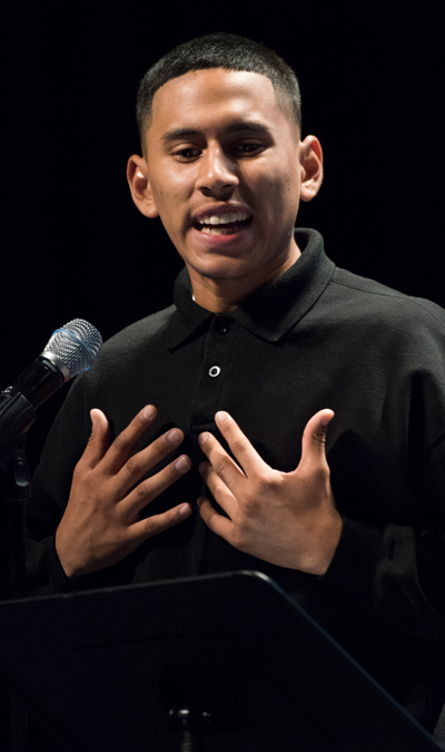 Student at microphone, gesturing