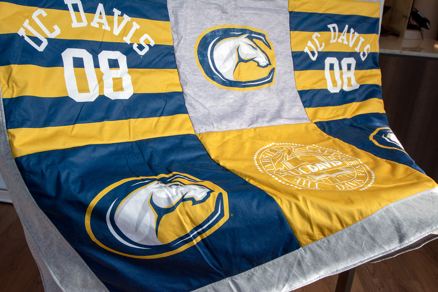 Blanket with patchwork of UC Davis logos