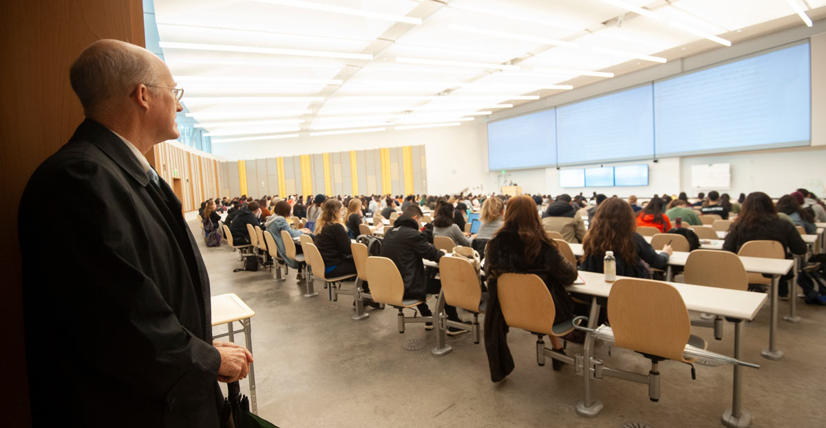 Ken Burtis stands at the back of California Hall during a lecture.