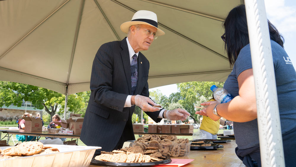 Ken Burtis passes out cookies at TGFS.