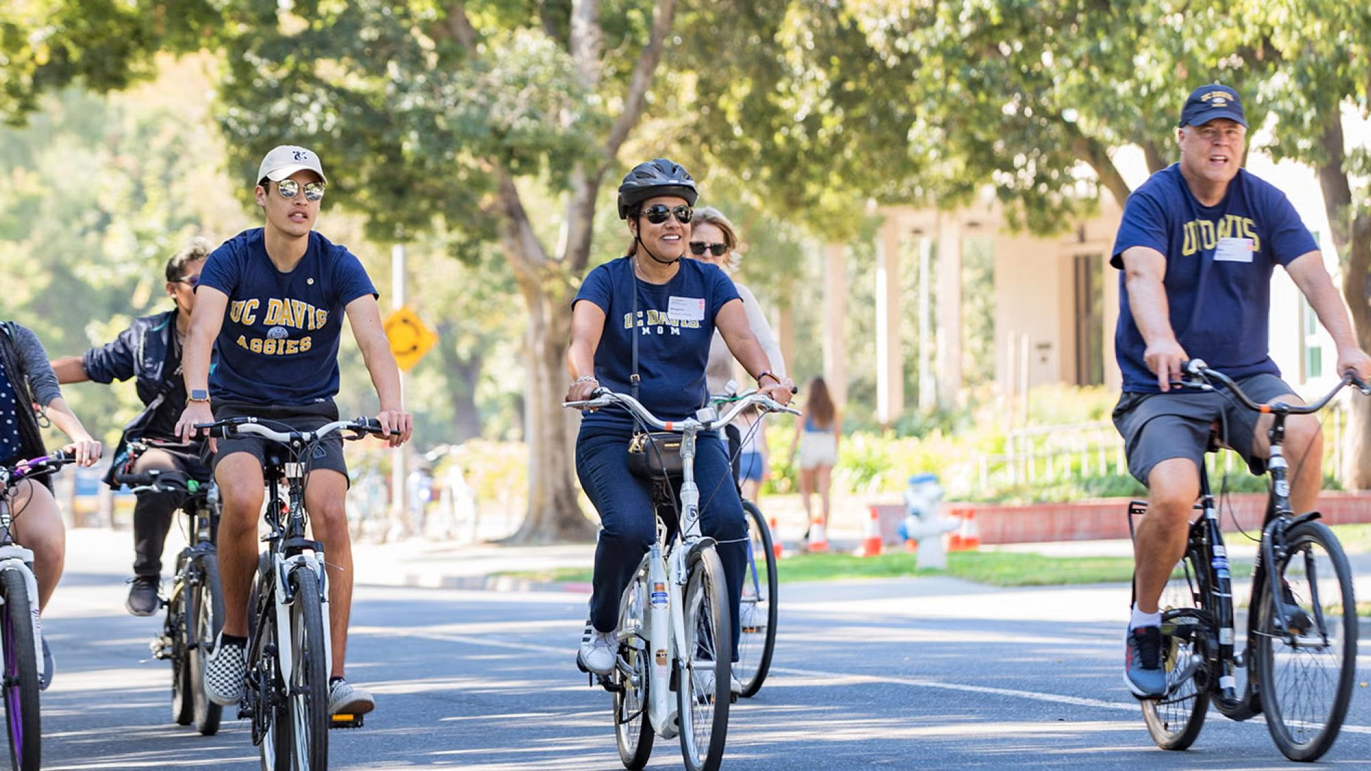 Touring families on bikes enjoying the campus