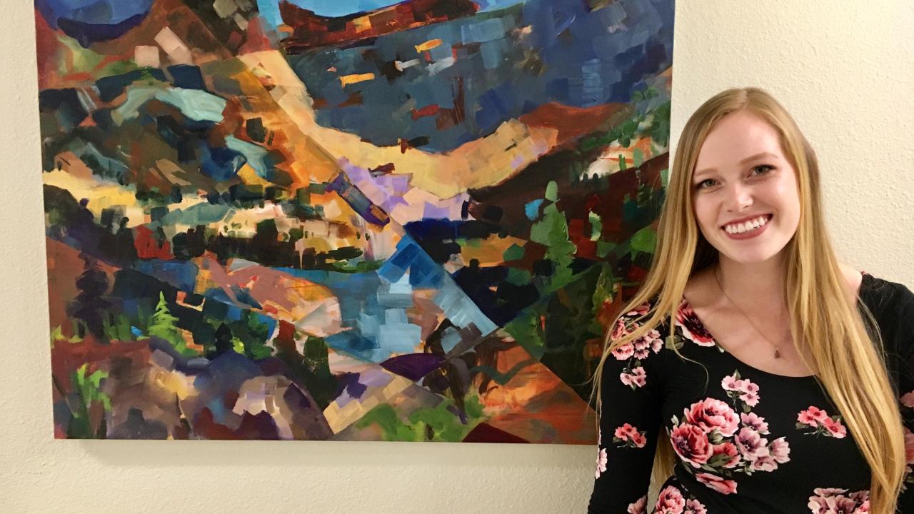 Fourth-year art studio major McKinna Salinas stands in front of her work, "Mountain Yellow-legged Frog." 