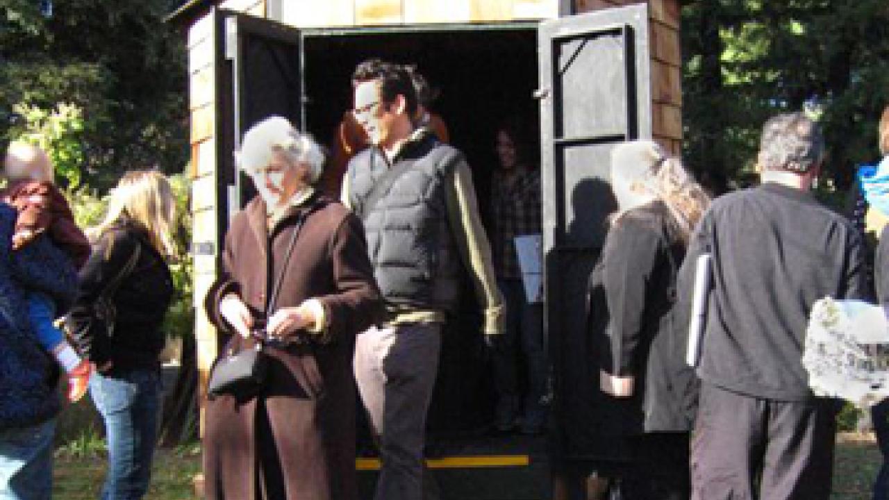 People visit the camera obscura in the UC Davis Arboretum.
