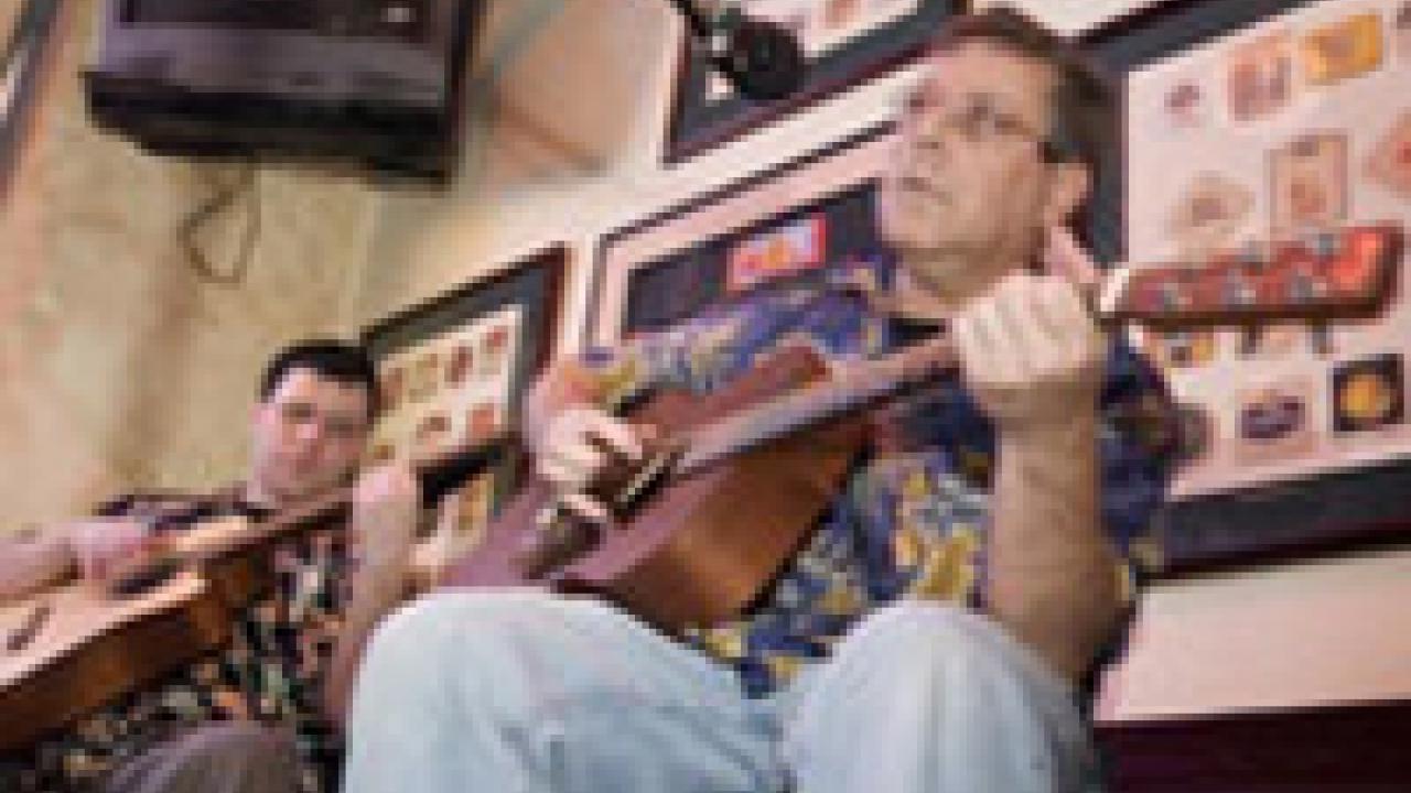 Spanish department faculty members Charles Oriel, right, and Travis Bradley perform with their band, Black Cat Bone, at the Sacramento Brewing Company in Sacramento on Dec. 9. 