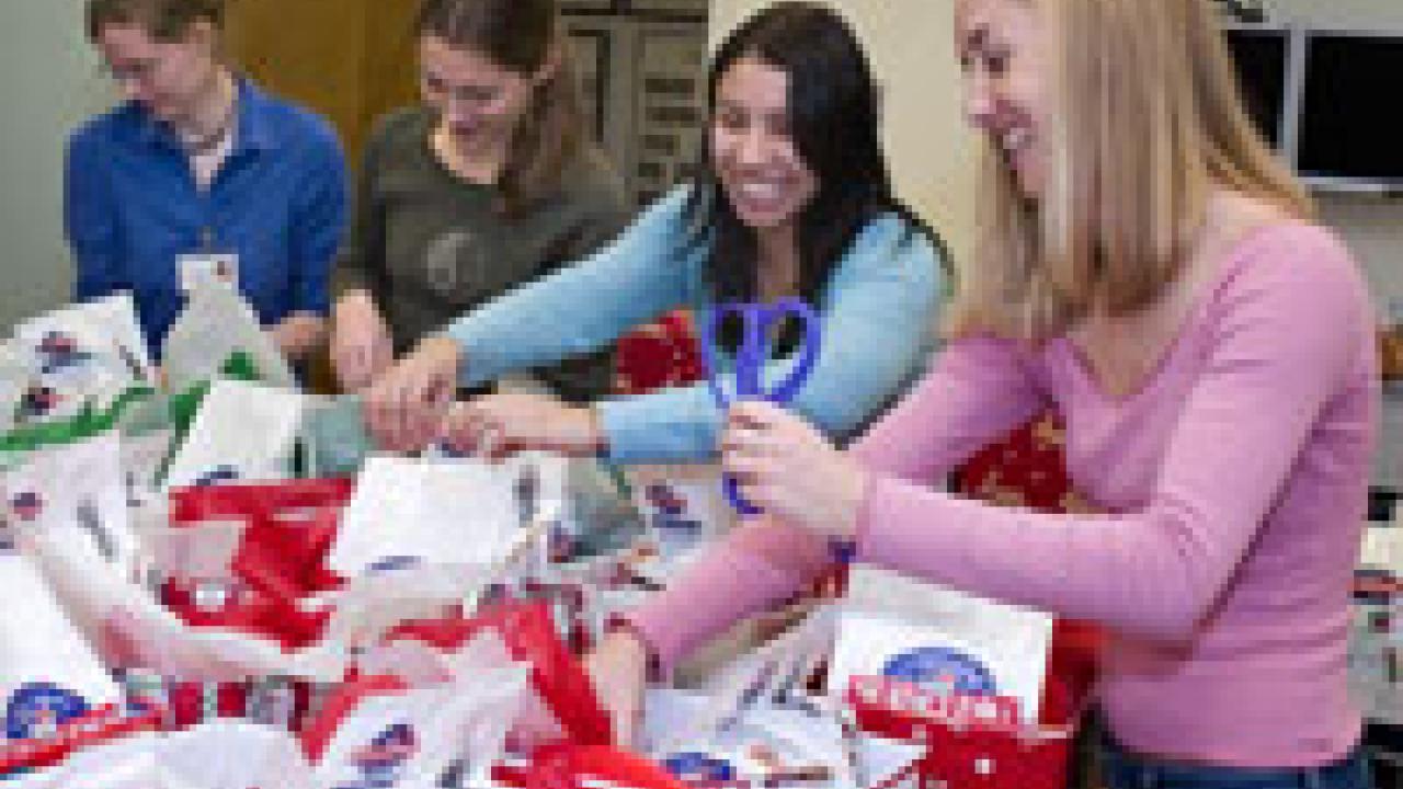Left to right: veterinary students Valerie Welch, Jen Jeske, Evelyn Sagastume and Casey Decino prepare baskets of donated pet gifts on Dec. 9 to take to homeless pet owners at Loaves and Fishes in Sacramento. 