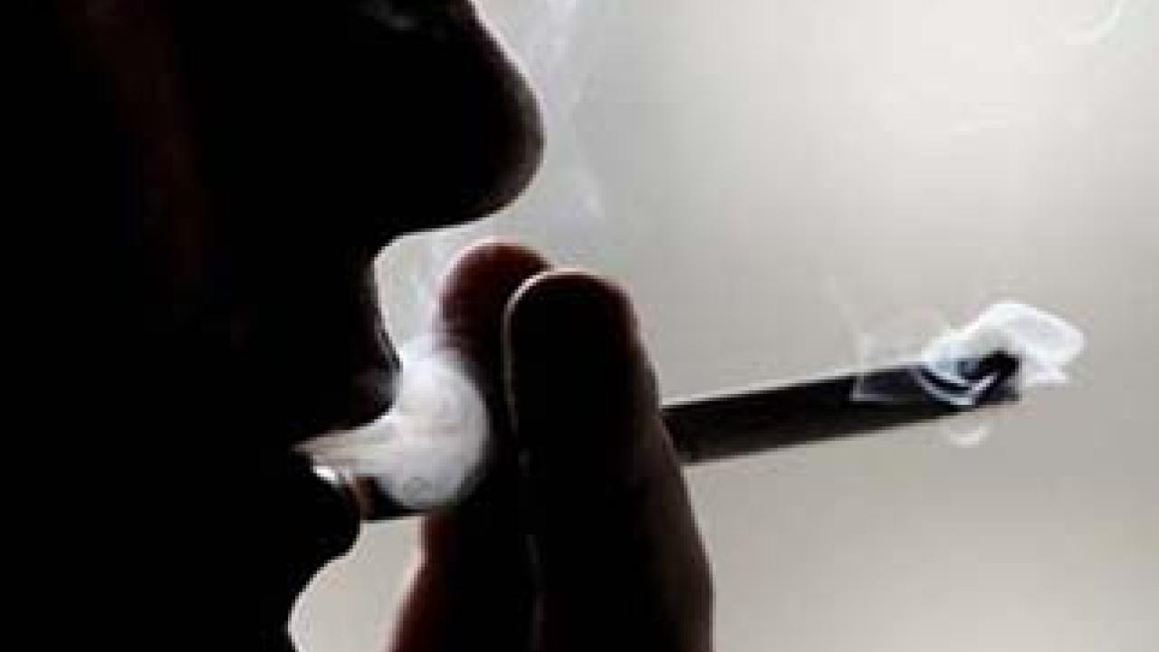 Unidentified person inhales on a cigarette.