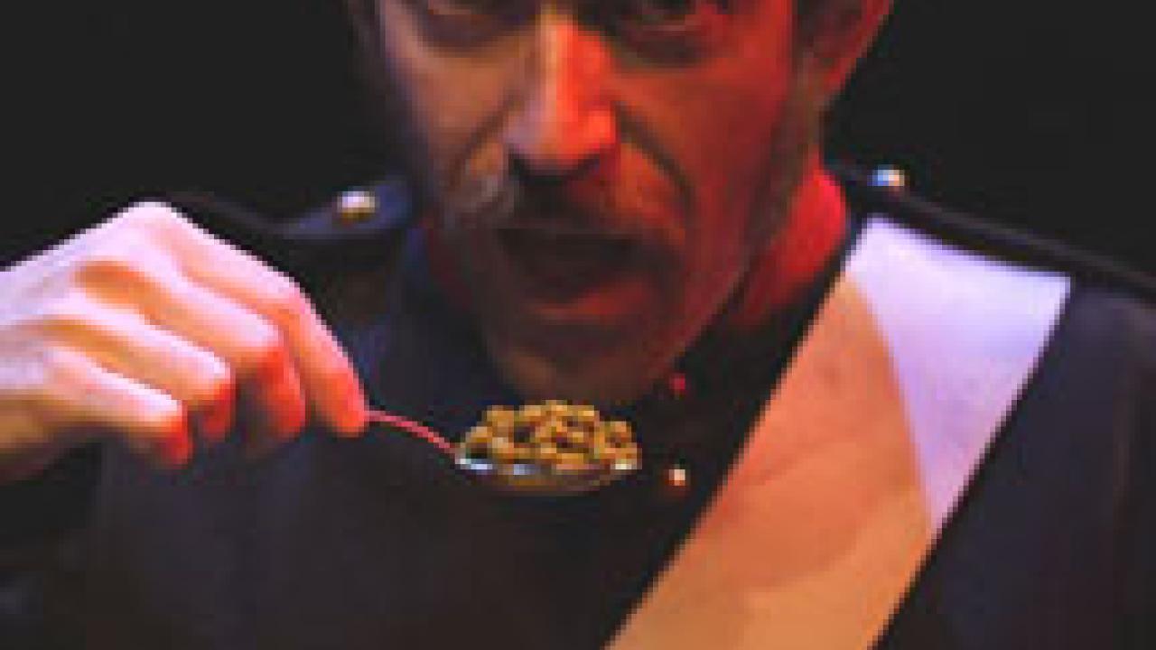 Title character Frank Woyzeck, played by Edward Snyder, is forced to eat peas as part of a cruel medical experiment in this scene from the Georg B&Atilde;&frac14;ch