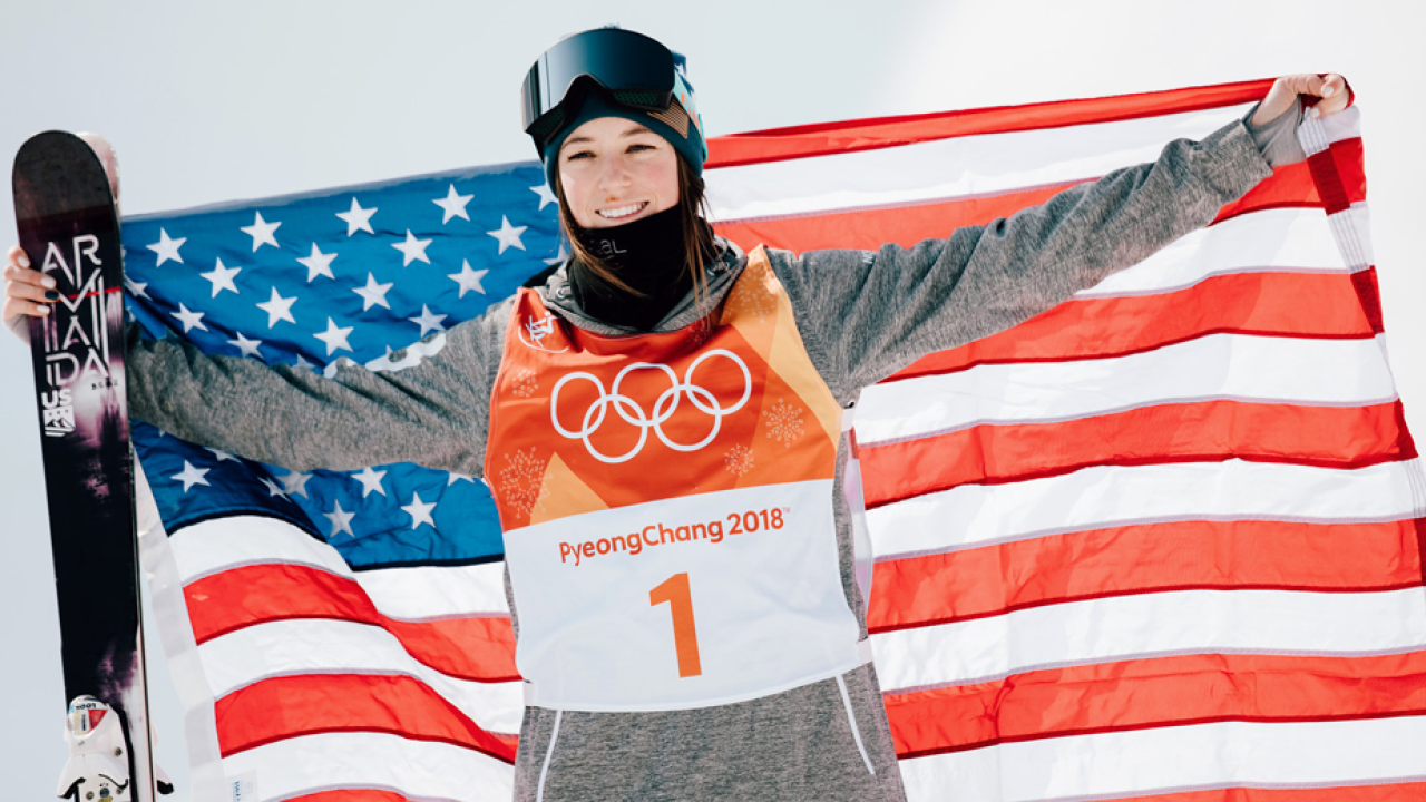 Brita Sigourney holds U.S. flag behind her back.
