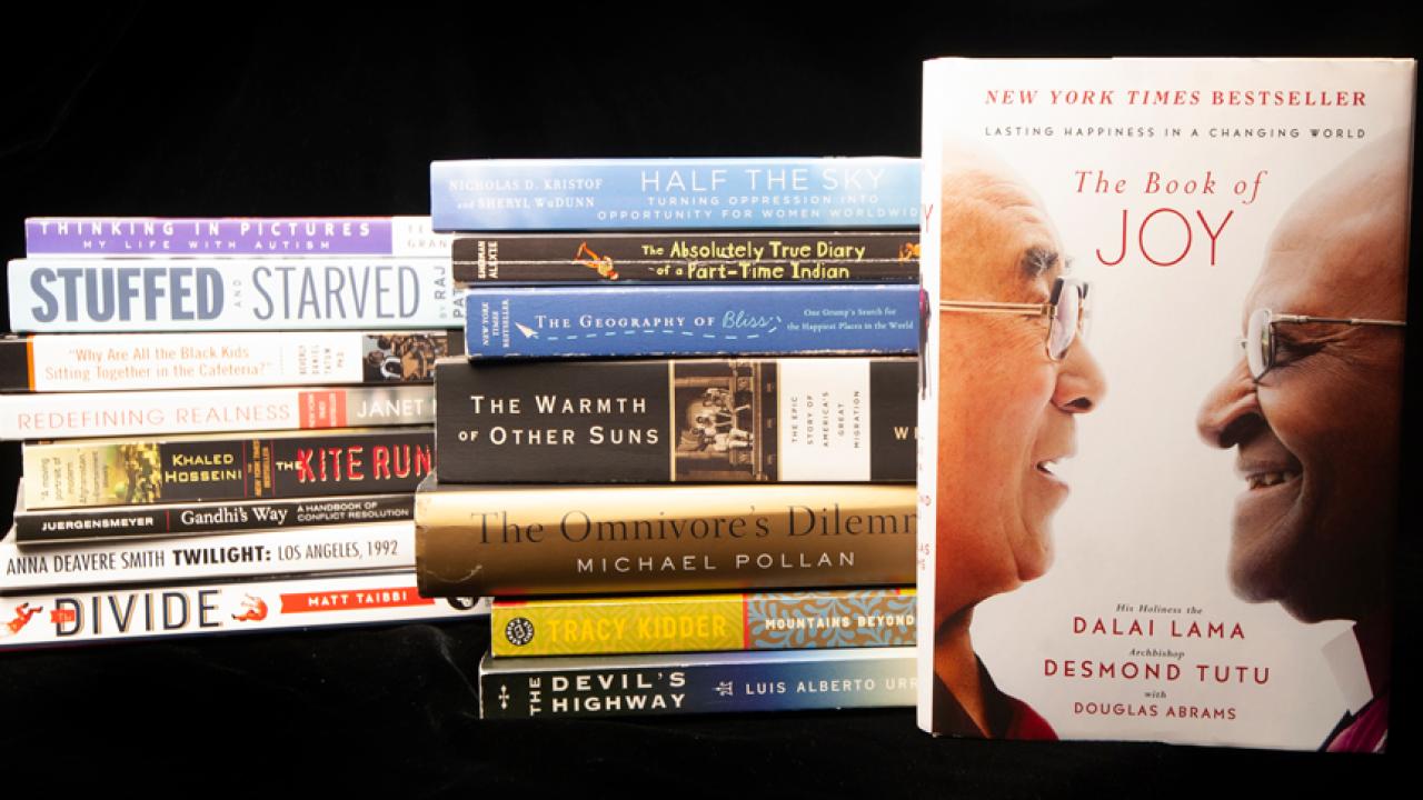 15 previous books, stacked, adjacent to "The Book of Joy"