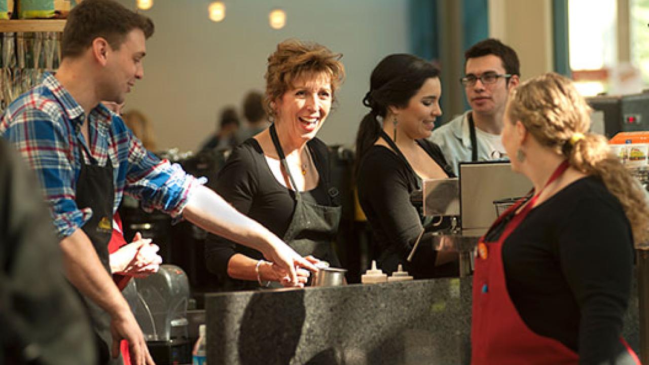Photo: Chancellor Linda P.B. Katehi at work behind the counter at Swirlz, with crewmates Andrew Stump, Lucy Avalos, Ryan Little and Lauren Woods.