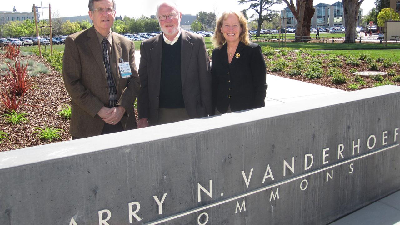 Trio stands behind the Larry N. Vanderhoef Commons sign.