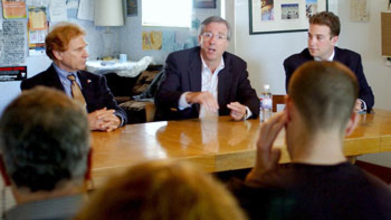 Hillel Damron, left,  executive director of Hillel in Davis and Sacramento, and Donald Cohen-Cutler, a UC Davis junior and international relations major, right, look on as Dennis Ross discusses foreign policy during one of his three campus talks