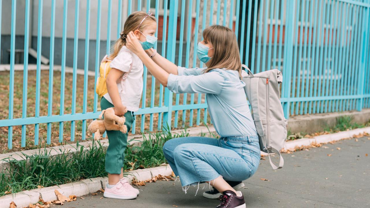 Girl and nanny in masks, outdoors