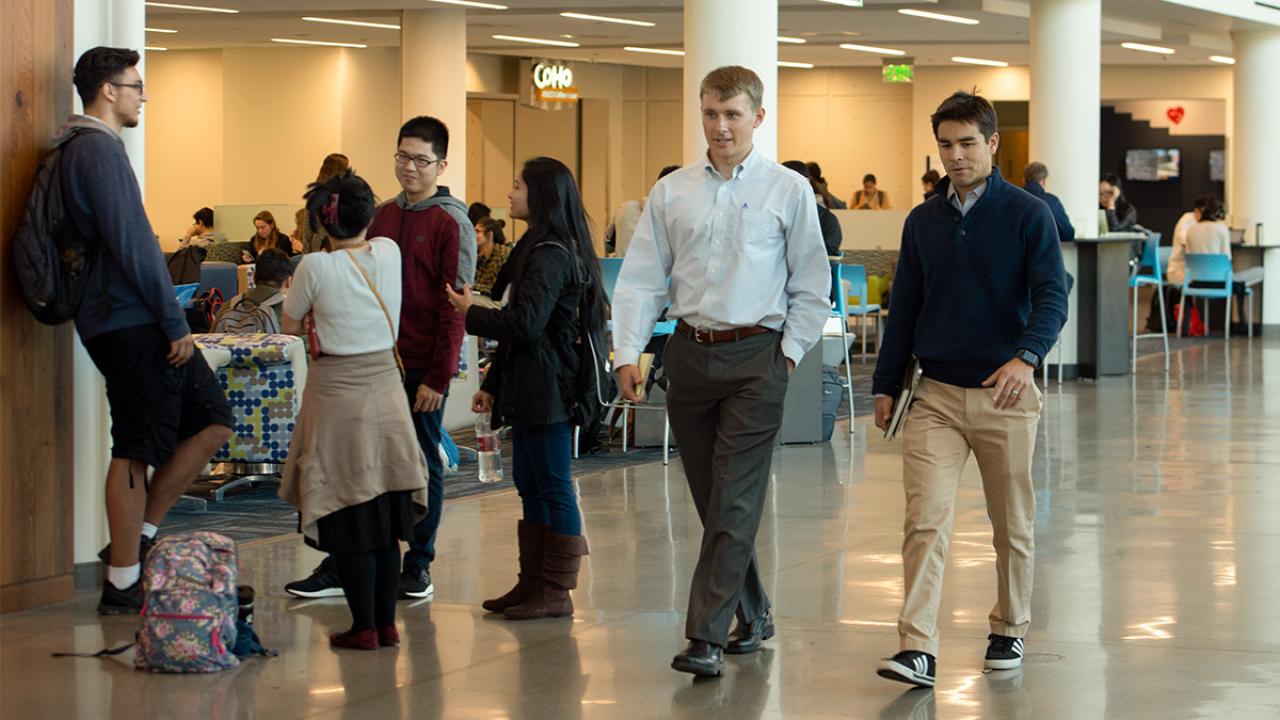 Kevin Blue walks with student in Memorial Union.